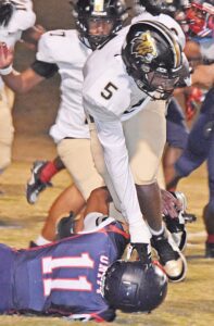 Blacksburg running back Trevon Clark puts a hand on a Chester player for balance Friday as he searches for running room in the playoff game.